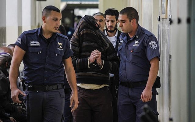 Police accompany to a Jerusalem court a teacher accused of harassing girls on the Internet (Photo credit: Flash 90) Police accompany to a Jerusalem court a teacher accused of harassing girls on the Internet (Photo credit: Flash 90)