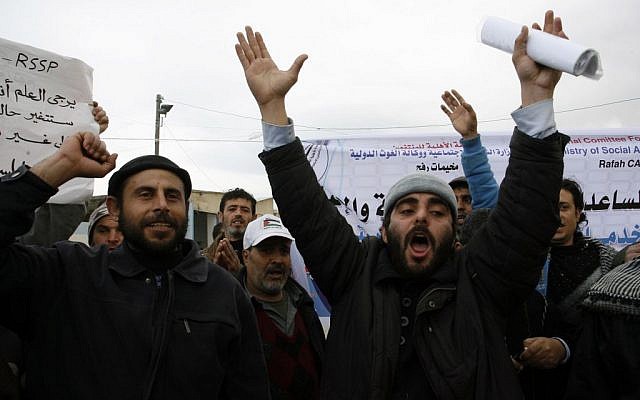 Palestinians protest in front of the UNRWA headquarters against their decision to reduce aid in the Rafah refugee camp in the southern Gaza Strip, on January 26, 2014 (photo credit: Abed Rahim Khatib/Flash90) Palestinians protest in front of the UNRWA headquarters against their decision to reduce aid in the Rafah refugee camp in the southern Gaza Strip, on January 26, 2014 (photo credit: Abed Rahim Khatib/Flash90)