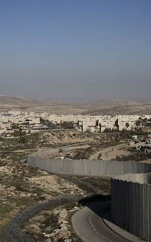 The security barrier separates the Shuafat refugee camp on the right from the Jewish neighborhood of Pisgat Zeev (photo credit: Hadas Parush/Flash90)
