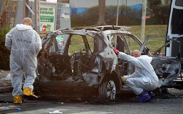 Illustrative: Members of the Israel police bomb squad investigate a car which exploded in the city of Petah Tikvah, February 3, 2014. (Photo credit: Gideon Markowicz/Flash90) Illustrative: Members of the Israel police bomb squad investigate a car which exploded in the city of Petah Tikvah, February 3, 2014. (Photo credit: Gideon Markowicz/Flash90)