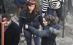 Natalie Portman (R) in Jerusalem's Nahlaot neighborhood directing a scene from 'A Tale of Love and Darkness,' February 11, 2014. (Yonatan Sindel/Flash 90)