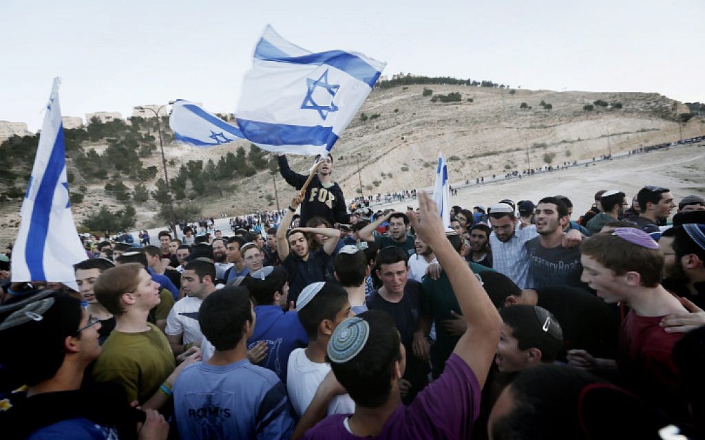 Settlers and right wing activists hold evening prayers after attending a march in the area known as E1 near the settlement of Ma'ale Adumim on February 13, 2014. (Miriam Alster/Flash90) Settlers and right wing activists hold evening prayers after attending a march in the area known as E1 near the settlement of Ma'ale Adumim on February 13, 2014. (Miriam Alster/Flash90)