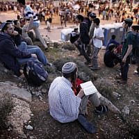Israelis settlers and right wing activists hold evening prayers after attending a march in the area known as E1 near the Israeli settlement of Ma'ale Adumim on February 13, 2014. (photo credit: Yonatan Sindel/Flash90) Israelis settlers and right wing activists hold evening prayers after attending a march in the area known as E1 near the Israeli settlement of Ma'ale Adumim on February 13, 2014. (photo credit: Yonatan Sindel/Flash90)