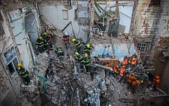Rescue personnel at the scene of an explosion that killed five and injured 11 in the northern city of Acre, Monday, February 17, 2014 (photo credit: Avishag Shaar Yashuv/Flash90)
