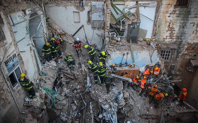 Rescue personnel at the scene of an explosion that killed five and injured 11 in the northern city of Acre, Monday, February 17, 2014 (photo credit: Avishag Shaar Yashuv/Flash90)
