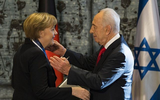 President Shimon Peres awards German Chancellor Angela Merkel the Presidential Medal of Distinction for her commitment to German-Israeli friendship, at the President's Residence in Jerusalem, 25 February 2014. (Yonatan Sindel/Flash90) President Shimon Peres awards German Chancellor Angela Merkel the Presidential Medal of Distinction for her commitment to German-Israeli friendship, at the President's Residence in Jerusalem, 25 February 2014. (Yonatan Sindel/Flash90)