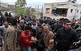 Palestinian residents evacuate the body of Mu'taz Washha from his house toward an ambulance after he was killed during a reported Israeli army operation, in the West Bank town of Bir Zeit, Thursday, Feb. 27, 2014 (photo credit: Issam Rimawi/Flash90)