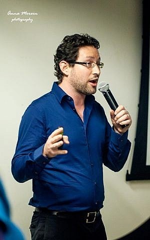 Amit Manna of Fashioholic, which provides fashion-themed cellphone games, speaks during a Fash&Tech pitch night Feb. 12 in Tel Aviv. A panel of judges chose Fashioholic from five startups as the winner of the pitch night. (Photo credit: Anna Morein)