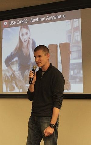 Danny Shir of SnapGet, an app that allows users to upload an image of a shoe and find similar products to buy, presents during a Fash&Tech pitch night Feb. 12 in Tel Aviv. The audience voted for Snapget as the winner among five startups. (The Times of Israel/Rebecca McKinsey)