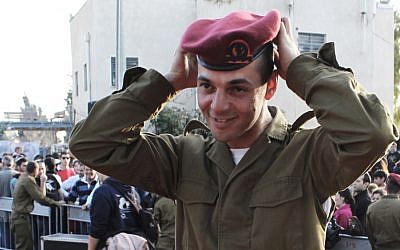 Private Isaac Moyal, 29, adjusts his new red beret after the ceremony that made him the oldest person to join the Paratroopers Brigade. (The Times of Israel/Rebecca McKinsey)