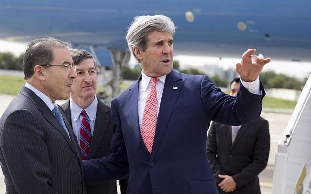 US Secretary of State John Kerry, right, talks with Tunisian Foreign Minister Mongi Hamdi, left, and ambassador Jake Walles after arriving at El Aouina Air Base Tuesday, February 18, 2014, in Tunis (photo credit: AP/Evan Vucci, Pool) US Secretary of State John Kerry, right, talks with Tunisian Foreign Minister Mongi Hamdi, left, and ambassador Jake Walles after arriving at El Aouina Air Base Tuesday, February 18, 2014, in Tunis (photo credit: AP/Evan Vucci, Pool)