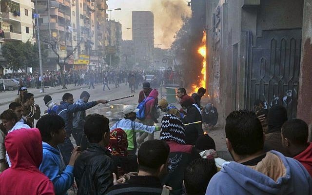 Supporters of Egypt’s ousted President Mohammed Morsi damage a police building in Cairo's Ain Shams district, Egypt, Friday, Feb. 7, 2014. (photo credit: AP/Mostafa Darwish) Supporters of Egypt’s ousted President Mohammed Morsi damage a police building in Cairo's Ain Shams district, Egypt, Friday, Feb. 7, 2014. (photo credit: AP/Mostafa Darwish)