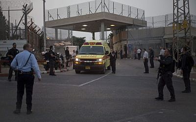 Illustrative: An ambulance leaves Rimonim Prison while Israeli police SWAT teams enter the prison, on Sunday, February 23, 2014. (AP/Ariel Schalit)