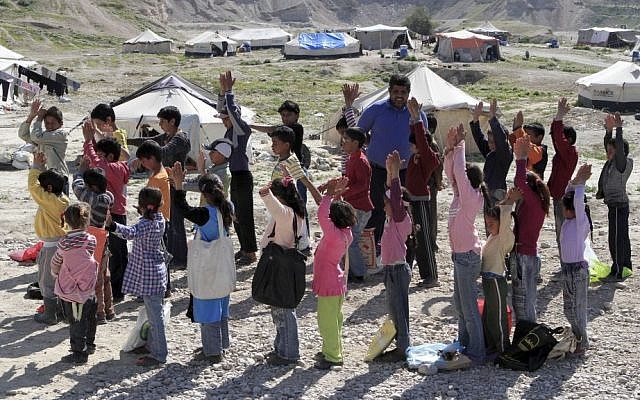 Jordanian volunteer teacher Mohammed Marahleh holds a physical education class for Syrian refugees in Northern Shuneh area of Jordan Valley, north of Amman, Jordan in February 2014. (photo credit: AP Photo/Raad Adayleh) Jordanian volunteer teacher Mohammed Marahleh holds a physical education class for Syrian refugees in Northern Shuneh area of Jordan Valley, north of Amman, Jordan in February 2014. (photo credit: AP Photo/Raad Adayleh)