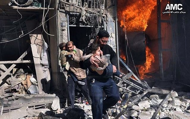 Syrian men help survivors out of a destroyed building after government warplanes attack Aleppo, Syria, on Feb. 8, 2014. (photo credit: AP/Aleppo Media Center AMC) Syrian men help survivors out of a destroyed building after government warplanes attack Aleppo, Syria, on Feb. 8, 2014. (photo credit: AP/Aleppo Media Center AMC)