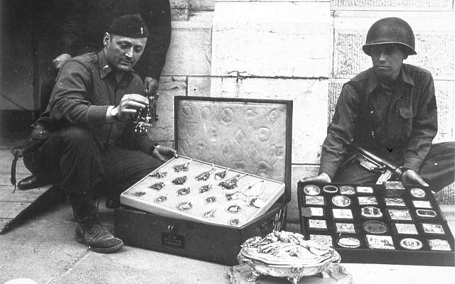 This photo provided by The Monuments Men Foundation for the Preservation of Art of Dallas, shows Monuments Man James Rorimer, left, and Sgt. Antonio Valim examining valuable art objects at Neuschwanstein Castle in Germany which were stolen from the Rothschild collection in France by the ERR and found in the castle in May of 1945. (AP Photo/National Archives and Records Administration) This photo provided by The Monuments Men Foundation for the Preservation of Art of Dallas, shows Monuments Man James Rorimer, left, and Sgt. Antonio Valim examining valuable art objects at Neuschwanstein Castle in Germany which were stolen from the Rothschild collection in France by the ERR and found in the castle in May of 1945. (AP Photo/National Archives and Records Administration)