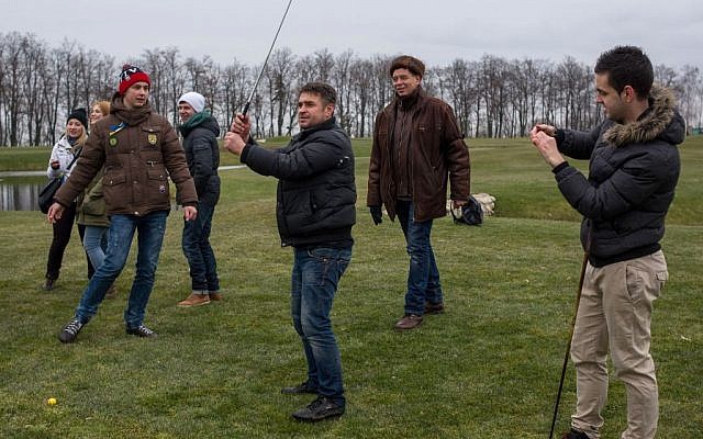 Protesters try to play golf at Victor Yanukovych's countryside residence in Mezhyhirya, Ukraine, Saturday, Feb, 22, 2014. (photo credit: AP/Andrew Lubimov)
