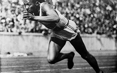 In this 1936 photo, American Jesse Owens runs in a 200-meter preliminary heat at the Summer Olympics in Berlin. Owens won four gold medals at the games, and showed up Adolph Hitler's idea of Aryan supremacy.  (AP Photo/File)