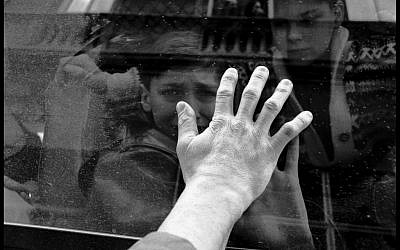 Haris Karalic, a Bosnian Muslim, bidding goodbye to his 13-year-old son Denis, who is leaving Sarajevo on a JDC rescue convoy, February 1994. (photo credit: Edward Serotta)