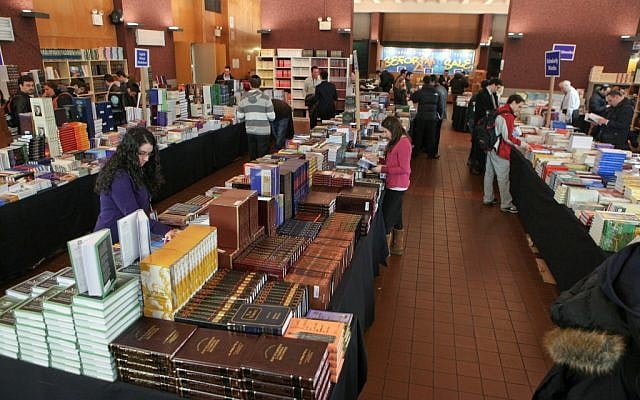 Piles of books at the annual Seforim Sale at Yeshiva University. (courtesy)