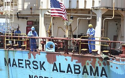 In this Nov. 22, 2009 file photo, crew members work aboard the U.S.-flagged Maersk Alabama after the ship docked in the harbour of Mombasa, in Kenya. Police in the Indian Ocean island nation of Seychelles said Wednesday, Feb. 19, 2014 that two American security officers were found dead Tuesday in a cabin on the Maersk Alabama, the ship hijacked by pirates in 2009, an event dramatized in the movie "Captain Phillips" starring Tom Hanks. (photo credit: AP Photo, File)