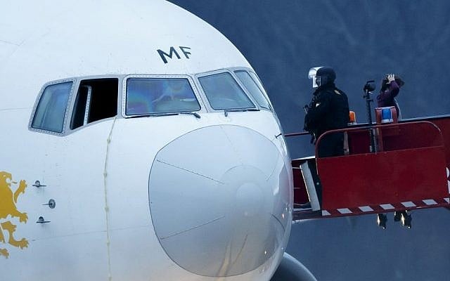 Police stand on the gangway after passengers were evacuated from a hijacked Ethiopian Airlines plane at the Geneva International Airport on Monday (photo credit: AP/Keystone/Salvatore Di Nolfi) Police stand on the gangway after passengers were evacuated from a hijacked Ethiopian Airlines plane at the Geneva International Airport on Monday (photo credit: AP/Keystone/Salvatore Di Nolfi)