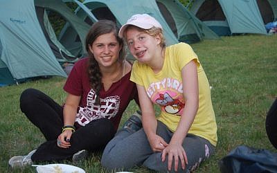 A child with disabilities hangs out with a peer at Camp Ramah Wisconsin. The Ramah camps were among the first Jewish camps to include children with disabilities. (Courtesy National Ramah Commission/JTA)