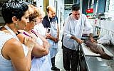 Students eagerly observe a fish being filleted at last summer's pilot for Open Restaurants. (photo credit: Tomer Foltyn)