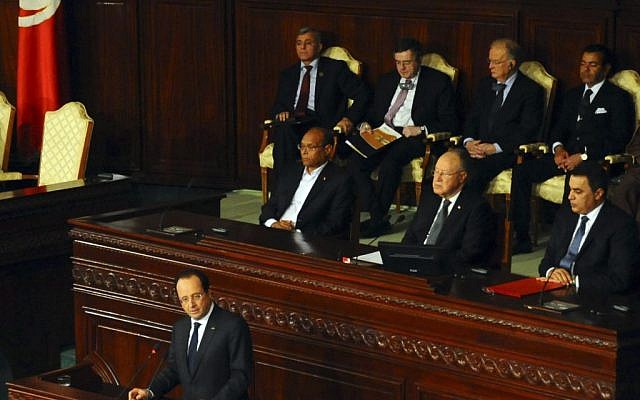 French President Francois Hollande delivers his speech, as first row, from left, Tunisian President Moncef Marzouki, Assembly speaker Mustapha Ben Jaafar, and Tunisian Prime Minister Mehdi Jomaa, listen during a ceremony at the Constituent Assembly in Tunis, Friday, Feb. 7, 2014. (photo credit: AP/Hassene Dridi) French President Francois Hollande delivers his speech, as first row, from left, Tunisian President Moncef Marzouki, Assembly speaker Mustapha Ben Jaafar, and Tunisian Prime Minister Mehdi Jomaa, listen during a ceremony at the Constituent Assembly in Tunis, Friday, Feb. 7, 2014. (photo credit: AP/Hassene Dridi)