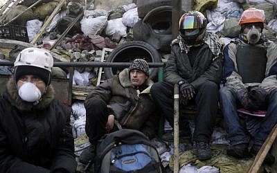 Anti-government protesters take a break on a barricade at Independence Square in Kiev, Ukraine, Friday, Feb. 21, 2014 (photo credit: AP/ Marko Drobnjakovic)