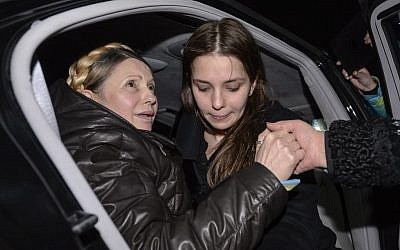 Former Ukrainian prime minister Yulia Tymoshenko, being helped out of her car by her daughter Eugenia, right, upon her arrival to Kiev's iconic Independence Square following her surprise release from prison. (photo credit: AP Photo/ Andrew Kravchenko)