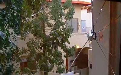 A view from the pierced window of Akim's hostel in northern Tel Aviv (Photo credit: YouTube screen capture)
