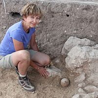 Archaeologist Diane Benton poses by the juglet filled with silver at the time of its discovery at Abel Beth Maacah. (photo credit: Robert Mullins)