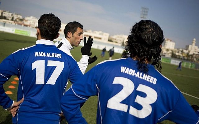In this Friday Feb. 7, 2014 photo, Wadi al-Nees players warm up before a league game at a stadium in Hebron, West Bank. (photo credit: AP Photo/Dusan Vranic)
