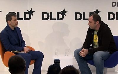 Jan Koum (R.) talks to David Rowan at DLD Munich 2014 (screen capture: YouTube)