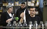 Illustrative: A Palestinian worker speaks with his Jewish employee at the SodaStream factory in the Mishor Adumim industrial park, February 2, 2014. (photo credit: Nati Shohat/Flash90)