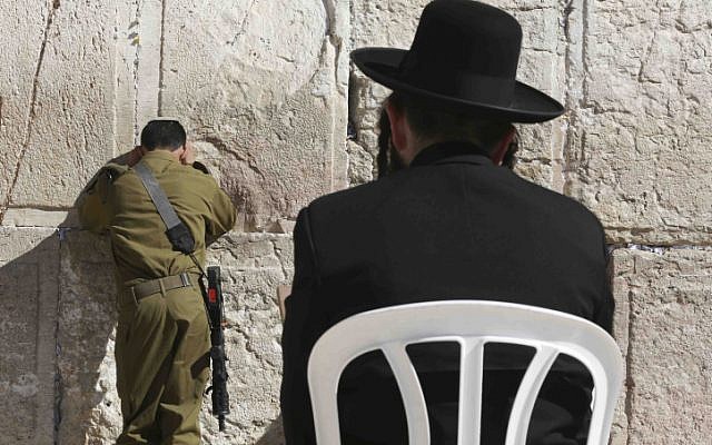 Could these two be in the same unit? In this illustrative photo of an Israeli soldier and ultra-Orthodox man pray at the Western Wall on February 2. (photo credit: Nati Shohat/FLASH90) Could these two be in the same unit? In this illustrative photo of an Israeli soldier and ultra-Orthodox man pray at the Western Wall on February 2. (photo credit: Nati Shohat/FLASH90)