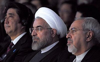 Iranian President Hassan Rouhani, center, and Foreign Minister Mohammad Javad Zarif, right, are seen during the World Economic Forum in Davos, Switzerland, on January 22, 2014. (photo credit: AFP/Eric Piermont)