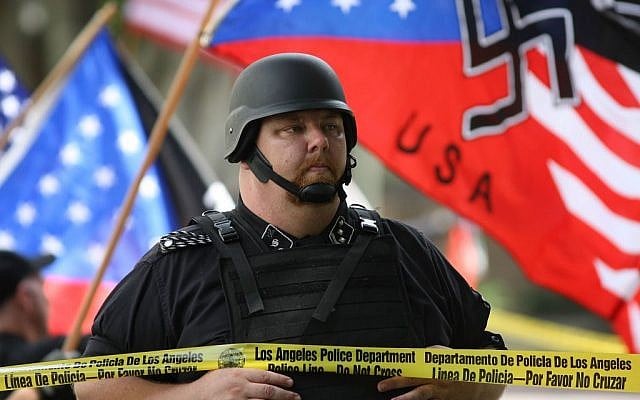 A member of the National Socialist Movement stands behind police tape line during a rally near Los Angeles City Hall on April 17, 2010. (David McNew/Getty Images/JTA)