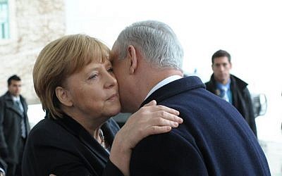German Chancellor Angela Merkel and Israeli Prime Minister Benjamin Netanyahu embrace after attending a joint press conference in Berlin, Germany. on December 6, 2012. (photo credit: Amos Ben Gershom/GPO/Flash90)