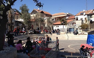 The cast and crew of 'A Tale of Love and Darkness' tucking into schnitzel and salad in a courtyard off Agrippas Street in Jerusalem (photo credit: Jessica Steinberg/Times of Israel)