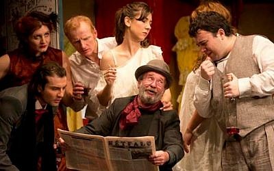Nicolae Botezatu, seated, and cast of Bucharest's Jewish State Theater performing last year. (The Jewish State Theater of Bucharest/JTA)