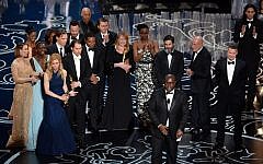 Director Steve McQueen (C) accepts the Best Picture award for '12 Years a Slave' with (back row) actors Sarah Paulson, Benedict Cumberbatch, Lupita Nyong'o, screenwriter John Ridley, actor Chiwetel Ejiofor, producers Arnon Milchan, Dede Gardner, Jeremy Kleiner and Anthony Katagas, actress Adepero Oduye and producer Brad Pitt onstage during the Oscars at the Dolby Theatre on March 2, 2014 in Hollywood, California. (Photo credit: AFP/Kevin Winter/Getty Images)