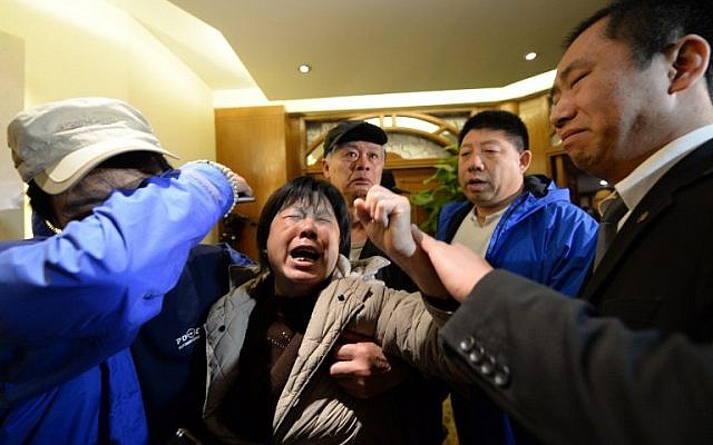 Angry relatives of missing passengers on Malaysia Airlines flight MH370 weep after hearing the news that the plane plunged into Indian Ocean, at a hotel in Beijing on March 24, 2014. (photo credit: AFP/ GOH CHAI HIN) Angry relatives of missing passengers on Malaysia Airlines flight MH370 weep after hearing the news that the plane plunged into Indian Ocean, at a hotel in Beijing on March 24, 2014. (photo credit: AFP/ GOH CHAI HIN)