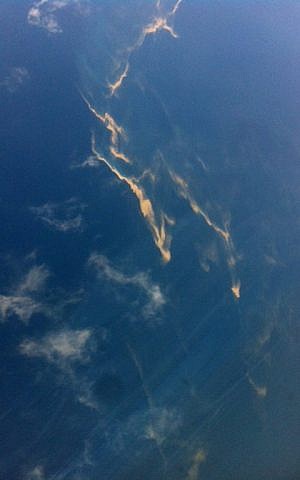 This picture taken on Saturday, March 8, 2014 shows an aerial view of an oil slick taken from a Vietnamese Air Force aircraft taking part in a search mission for a missing Malaysia Airlines aircraft, somewhere between Malaysia's east coast and southern Vietnam.  (photo credit: AFP/Thanh Nien Newspaper)
