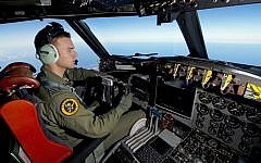A handout photo taken on March 19, 2014 shows Royal Australian Air Force pilot Flight Lieutenant Russell Adams flying his AP-3C Orion over the Southern Indian Ocean during the search for missing Malaysia Airlines flight MH370. (photo credit: AFP/Australian Defense/Sgt. Hamish Paterson)