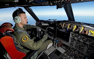 A handout photo taken on March 19, 2014 shows Royal Australian Air Force pilot Flight Lieutenant Russell Adams flying his AP-3C Orion over the Southern Indian Ocean during the search for missing Malaysia Airlines flight MH370. (photo credit: AFP/Australian Defense/Sgt. Hamish Paterson)