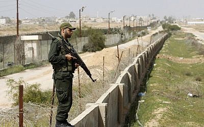 A member of the Palestinian security forces, loyal to Hamas, stands guard along the border between Egypt and the Gaza Strip on March 5, 2014. (photo credit: AFP PHOTO/ SAID KHATIB)