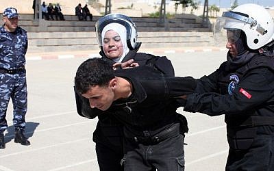 Palestinian policewomen take part in a training session that aims at preparing a special women's unit to intervene during riots, in the West Bank city of Jericho (Photo credit: Abbas Momani/AFP)