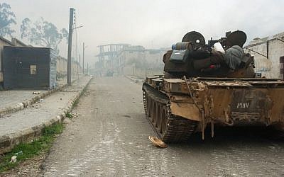 A tank on a street in the town of Zara, in the province of Homs, during fighting between Syrian forces and rebels, Saturday, March 8, 2014 (photo credit: AFP/STR)